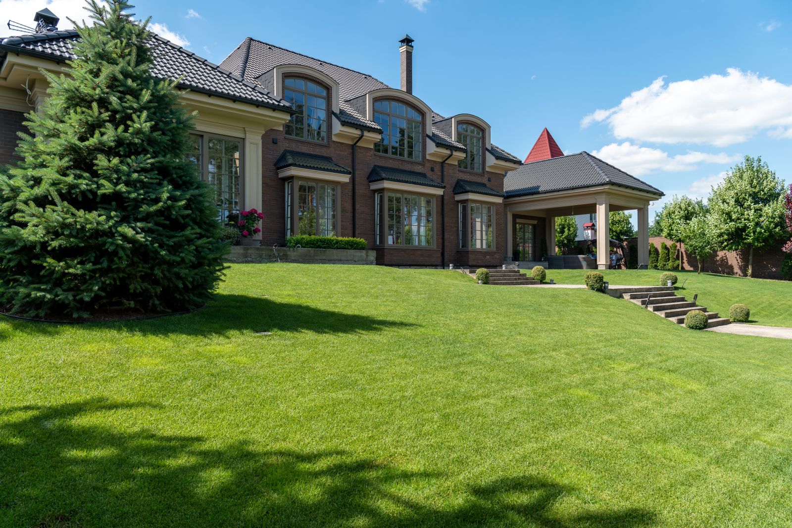 A lush, manicured green lawn in front of a home